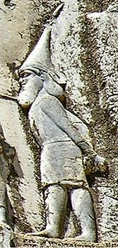 Stone carving of a Scythian man wearing a tall pointed hat