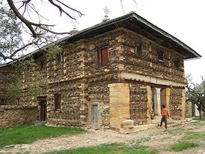 A rectangular two-story building with a flat roof and small windows and doors - East African history