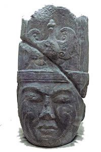 stone carving of a central asian man's head with a fancy hat on