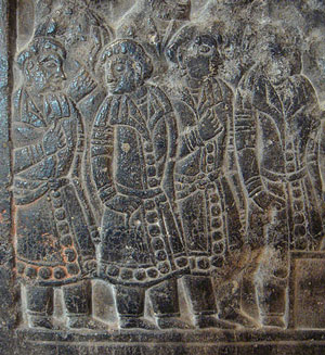 stone carving of Sogdian traders wearing fancy belted robes