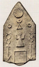 a tombstone with a pointed top and a carving of a woman and a moon 