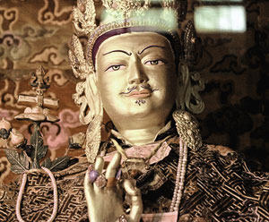 a gold statue of a Tibetan man