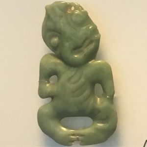 Green stone carving of a little person