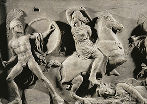 stone carving of women fighting with men on horses