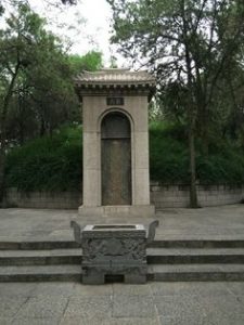 A stone niche and stone steps in a garden: The tomb of Bai Juyi