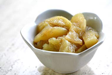 baked apples, sliced and in a small white china bowl