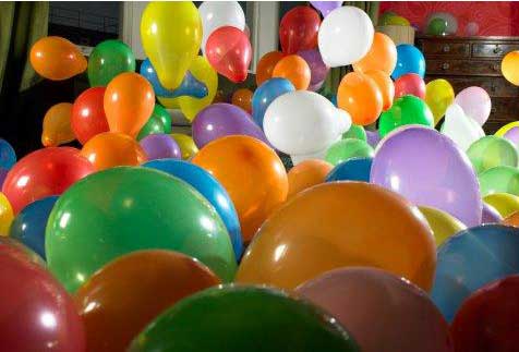 a room full of colorful helium balloons