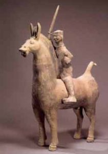 Clay model of a Han Dynasty man riding a horse with a sword lifted high