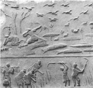 molded brick showing a man hunting birds with a bow, while in the foreground people harvest a field with sickles
