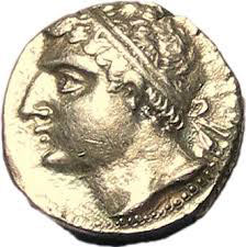 profile of a white man with a large nose, curly hair, and a headband, on a gold coin