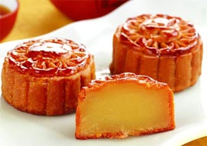 Chinese moon cakes - small round yellow caks with brown sugar on the outside