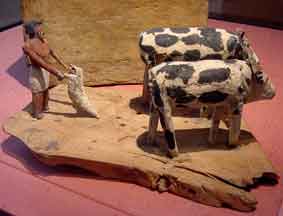 Wooden model of an Egyptian man plowing with two oxen