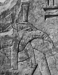 Stone carving of a person with the head of a bird - the Egyptian god Set