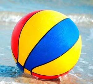 A beach ball in the sand.