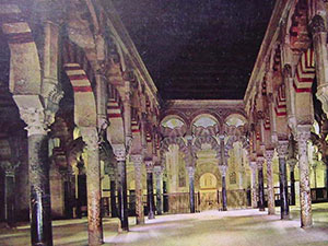 Red and white striped arches and mismatched Roman columns in the Cordoba mosque - Mosque history