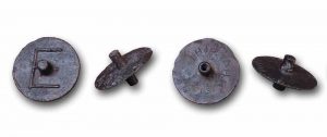metal disks shaped like tops; one has a closed end to the top and the other has an open end