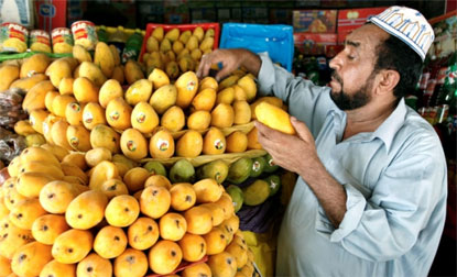 An Indian man selling mangoes