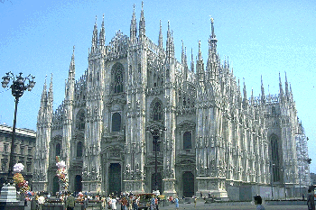 Milan cathedral - Gothic cathedral with five sets of windows across the wide facade and many tiny stone pinnacles