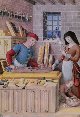 A medieval carpenter works in his shop.
