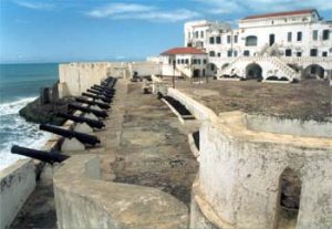 Slave fort: white buildings along a beach