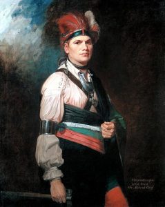 Joseph Brant, standing wearing dramatic European clothing
