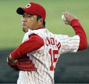 A Latino baseball player throwing a ball