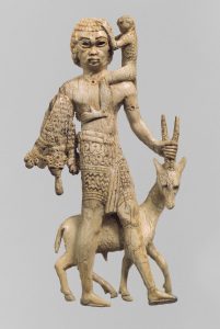 An Assyrian ivory from the 700s BC showing a Nubian man with an oryx, a monkey, and leopard skins, bringing them to the Assyrian king Assurnasirpal II