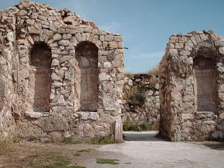 stone walls with arched niches around a courtyard