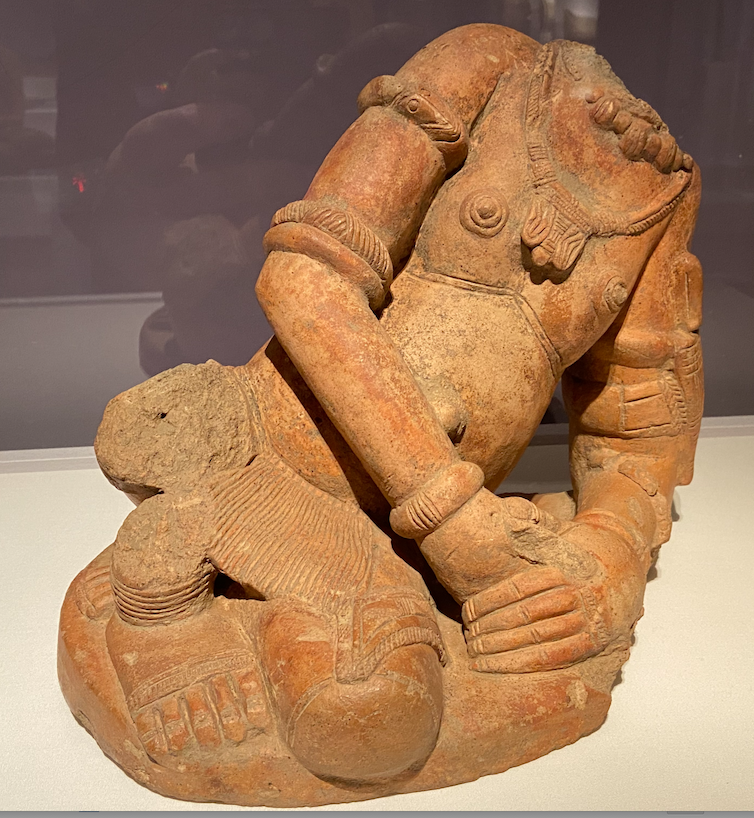 clay statue (headless) of a person reclining